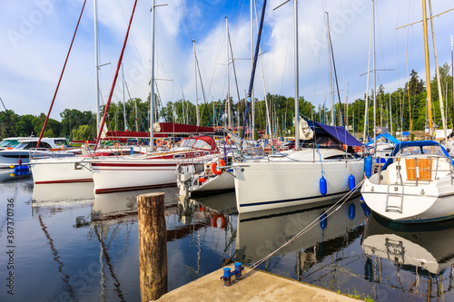 Sailboats mooring in small port at sunrise time, Ruciane Nida, Mazury Lake Di...