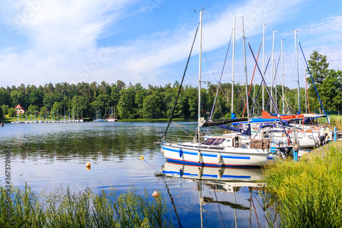 Sailboats reflection in lake Nidzkie near Ruciane Nida town, Mazury Lake District, Poland