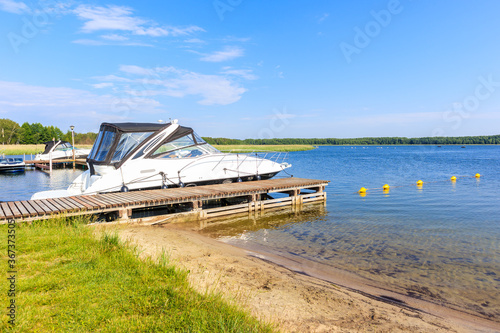 Boats anchoring at beach in Pisz sailing port on Lake Ros on summer sunny day   Masurian Lakes  Poland