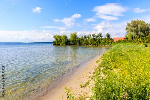 Beautiful sandy beach in sailing port Nowe Guty on Lake Sniardwy on summer su...