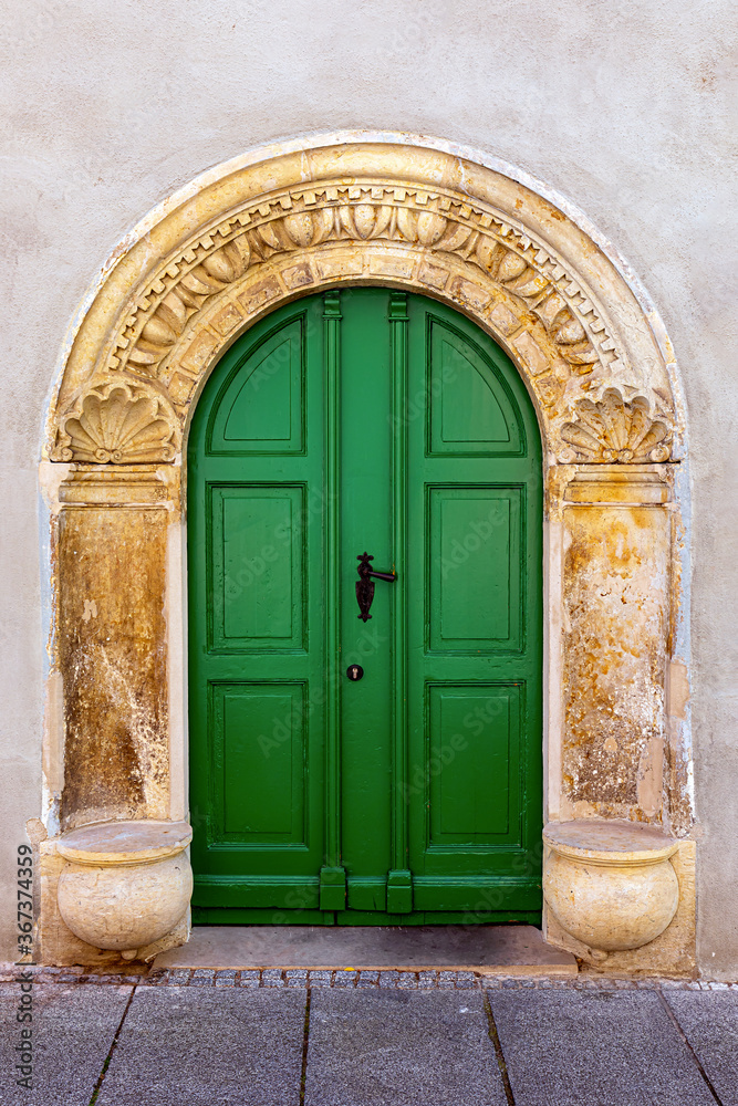 Green door inserted into an old Arch framed with Ornament Green door inserted into an old Arch framed with Ornament