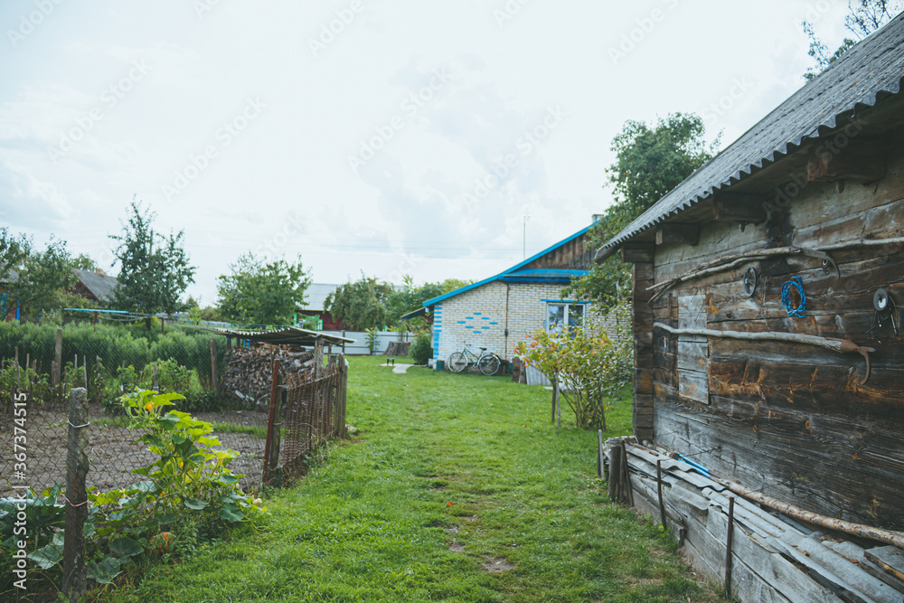 An old abandoned wooden building in a village manor. A structure made of cracked, sun-burned logs. An old abandoned wooden building in a village manor. A structure made of cracked, sun-burned logs.