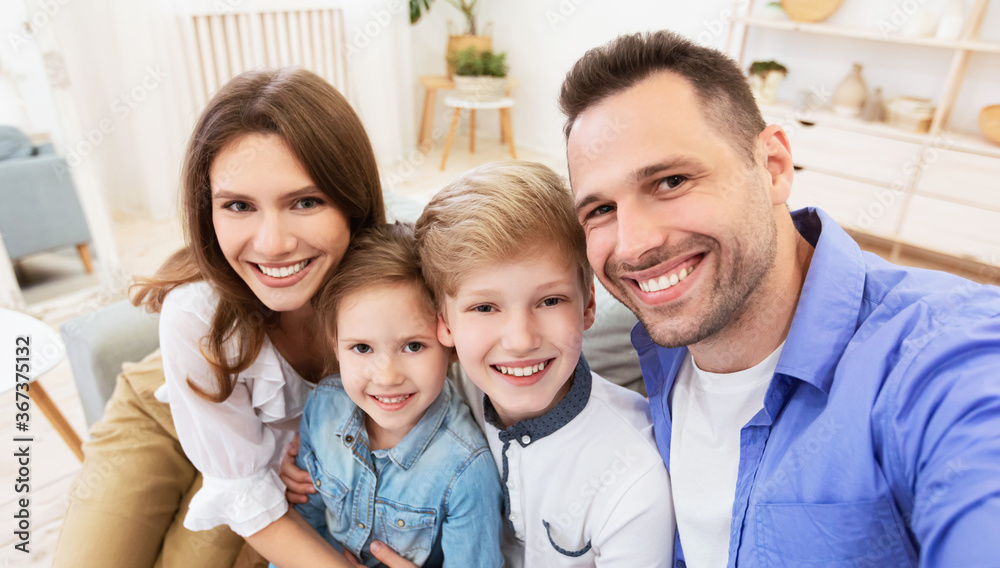 Happy Parents And Children Smiling Posing To Camera At Home Happy Parents And Children Smiling Posing To Camera At Home