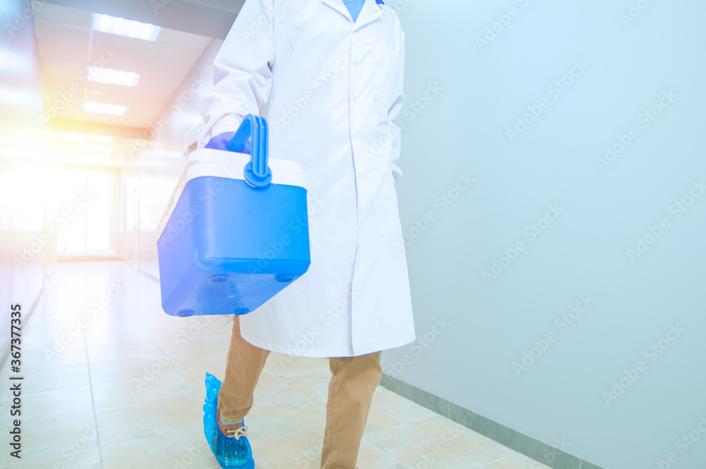 Medical worker, nurse, doctor holding a portable refrigerator bag.