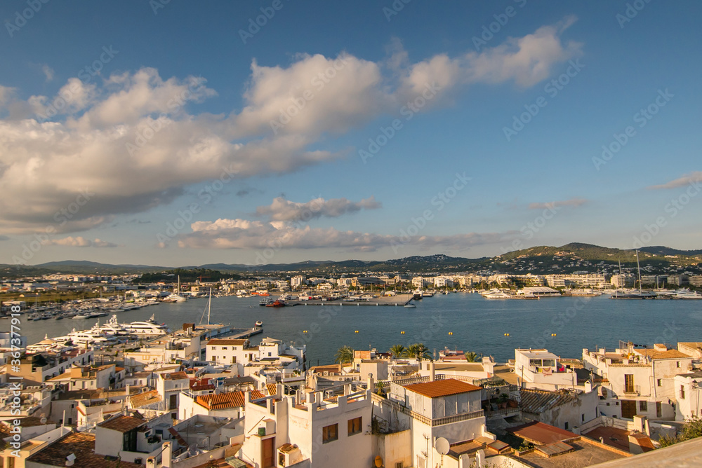 Colorful view of Ibiza harbor surrounded by houses, beautiful landscape of a sunny summer day