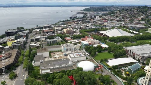 Aerial / drone footage, pan shot of the Seattle waterfront, Belltown, Elliott Bay, Puget Sound streets without people downtown, in the commercial district of Seattle, Washington during the pandemic
