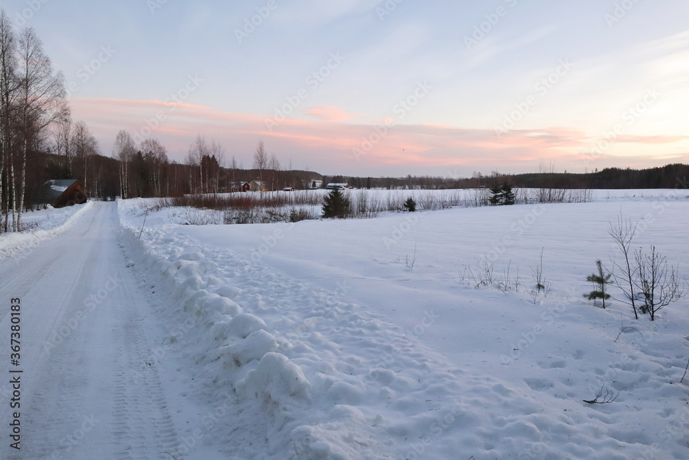 Lonely street in wintertime in the countryside of Lapland, Sweden
