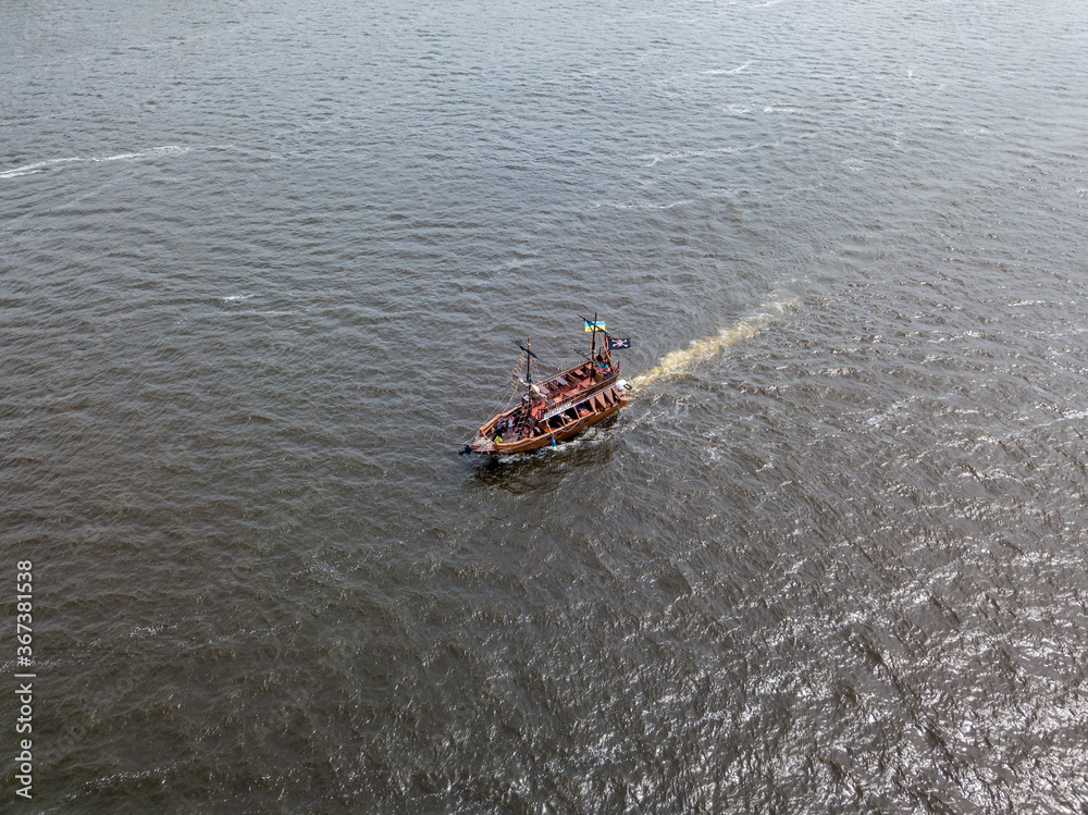 Obraz premium Aerial drone view. A pirate motor boat sails along the Dnieper River in Kiev.