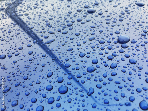 Water drops at blue car paint. Polishing and detailing cars