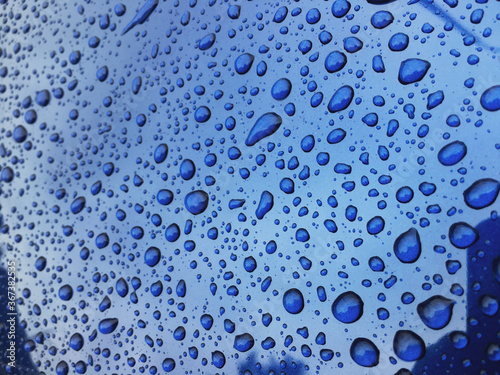 Water drops at blue car paint. Polishing and detailing cars