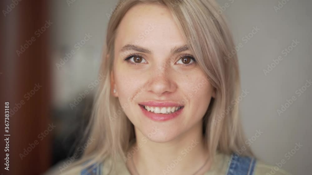 A portrait of the face of a smiling blonde girl A portrait of the face of a smiling blonde girl
