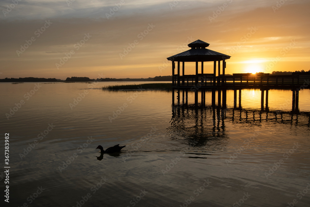 Sunrise over a gazebo at a small lake in a central Florida retirement community