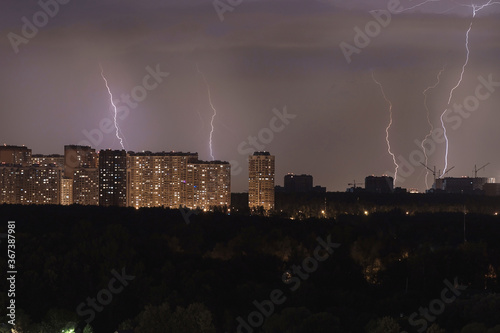 Silhouette of the night city. Lightning over the city. Storm over a residential area. lightning flashes on the horizon.