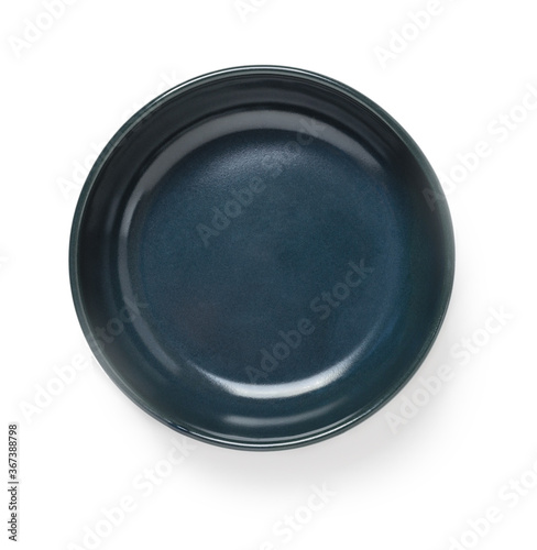 Empty dark blue ceramic bowl or ramekin isolated on a white background. Empty crockery for food design. Clay, ceramics or porcelain tableware.