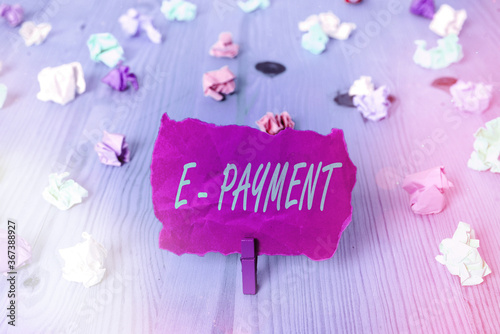 Text sign showing E Payment. Business photo text paying for goods or services on the internet E meaning electronic Colored crumpled rectangle shaped reminder paper light blue background photo