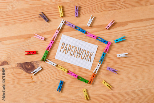 Writing note showing Paperwork. Business concept for routine clerical or recordkeeping work often incidental Colored clothespin papers empty reminder wooden floor background office photo