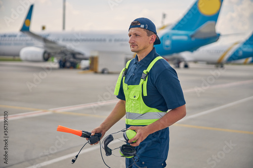 Airport worker gazing fixedly into the distance photo