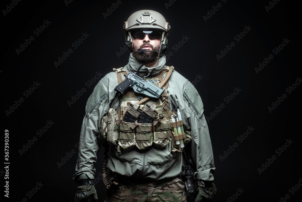 portrait of a soldier in a military uniform with a weapon on a dark background, a commando in military ammunition, the fight against terrorism concept portrait of a soldier in a military uniform with a weapon on a dark background, a commando in military ammunition, the fight against terrorism concept