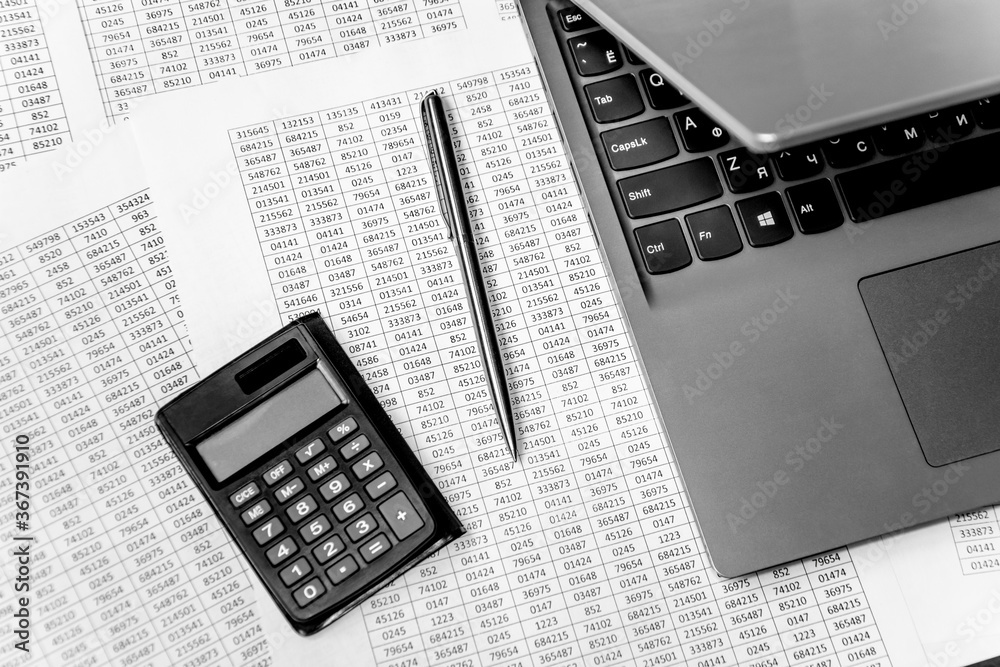 Top view of working space with financial reports, laptop, calculator and pen. Top view. Business planning concept on white. Top view of working space with financial reports, laptop, calculator and pen. Top view. Business planning concept on white.