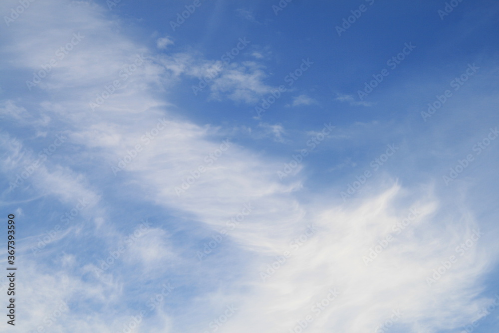 feather clouds on a blue sky background