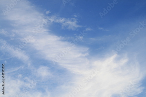 feather clouds on a blue sky background