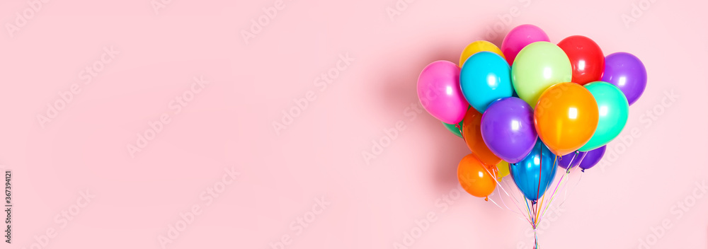 Bunch of bright balloons on pink background, space for text. Banner design - obrazy, fototapety, plakaty 