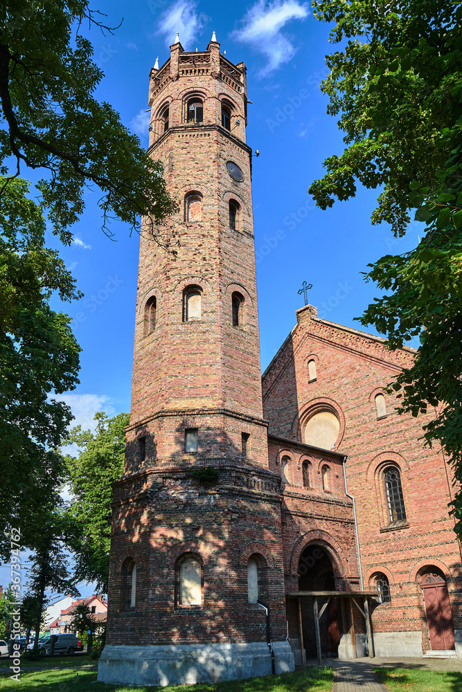 The tower of the historic, Gothic red brick church in the city of Skwierzyna The tower of the historic, Gothic red brick church in the city of Skwierzyna