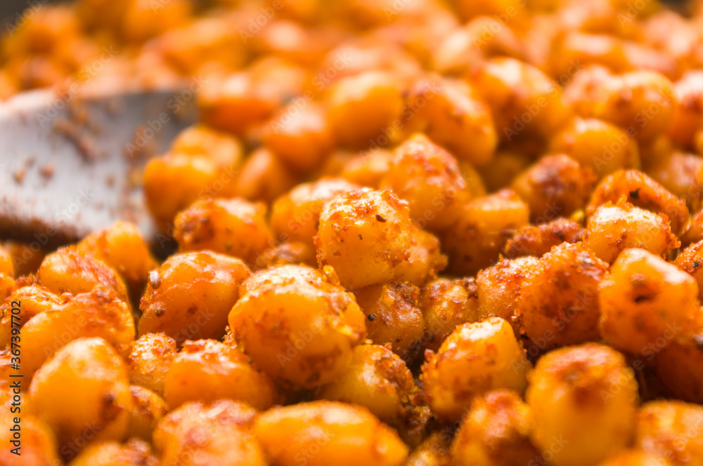 Cooking chickpeas with spices in a pan, close-up Cooking chickpeas with spices in a pan, close-up