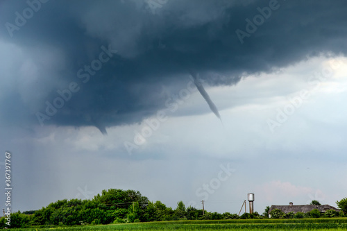 Tornado atmospheric whirlwind in a cumulonimbus thundercloud