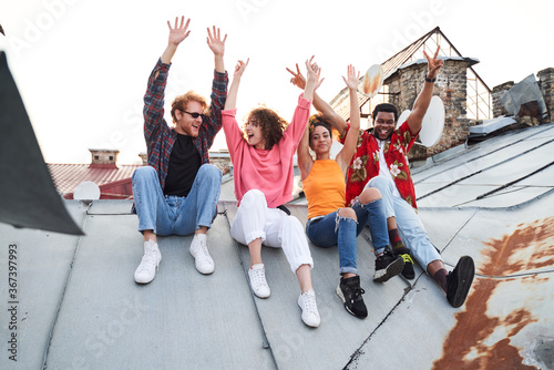 Jolly four people having fun on urban roof