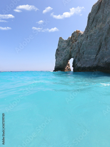 Fototapeta Naklejka Na Ścianę i Meble -  Sea level and underwater ultra wide photo of Lalaria beach, one of the most beautiful in Greece and one that made Skiathos island famous with arch like rock formation, Sporades islands