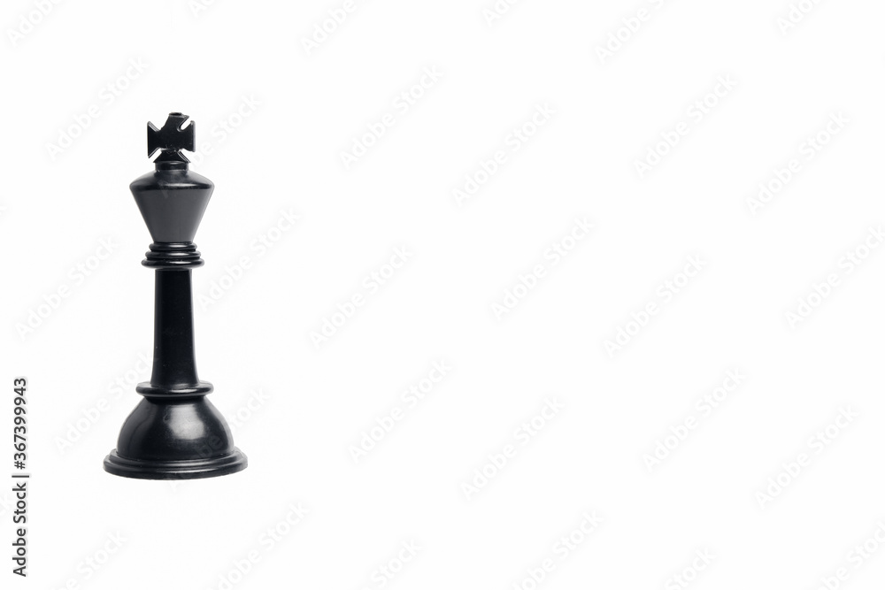 King maker concept with chess black king on isolated copyspace white background. King maker concept with chess black king on isolated copyspace white background.