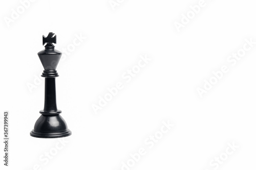 King maker concept with chess black king on isolated copyspace white background.
