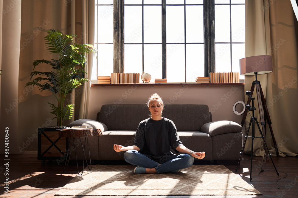 Calm woman relaxing with meditation at home