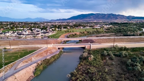 Wallpaper Mural Looking down at vehicles on a highway over a river then dolly back to reveal the city and mountains in the background - aerial hyperlapse Torontodigital.ca