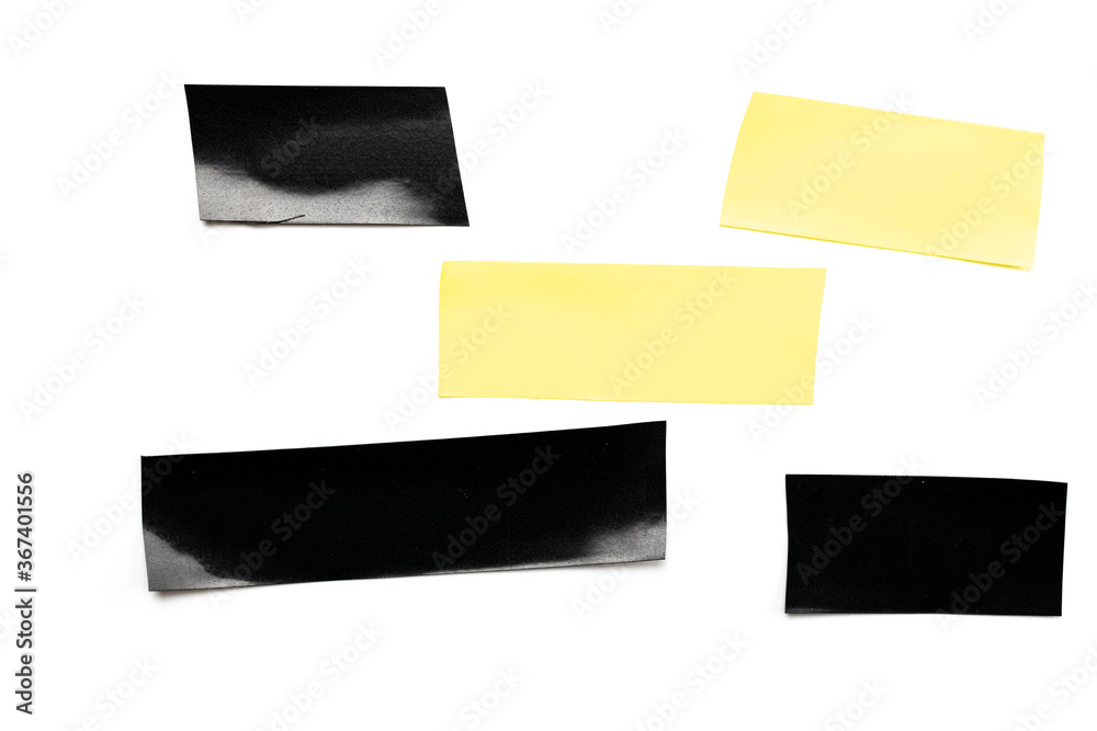 Adhesive sticky paper. Piece of yellow and black duct scotch tape isolated on white background. Torn strip grunge texture Adhesive sticky paper. Piece of yellow and black duct scotch tape isolated on white background. Torn strip grunge texture