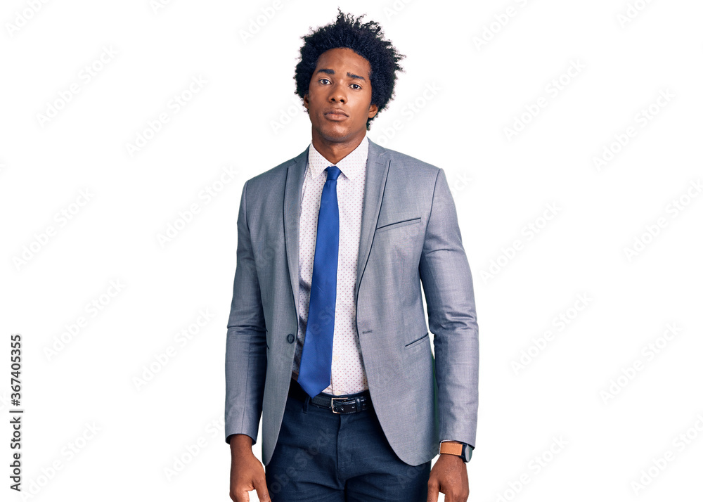Handsome african american man with afro hair wearing business jacket relaxed with serious expression on face. simple and natural looking at the camera. Handsome african american man with afro hair wearing business jacket relaxed with serious expression on face. simple and natural looking at the camera.