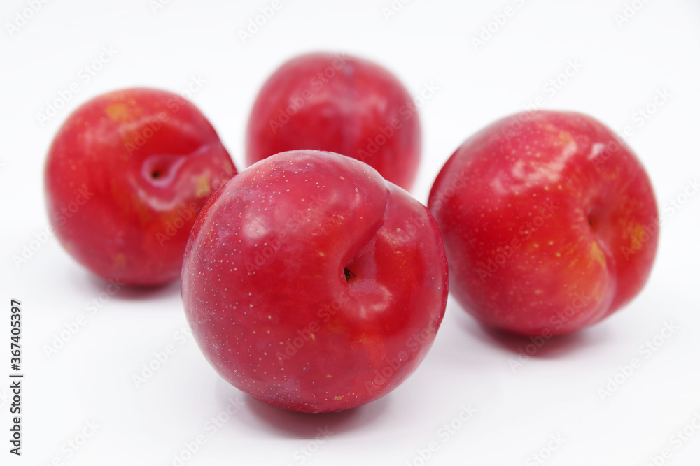 Plums isolated on a white background. Fresh plum. Closeup Plums isolated on a white background. Fresh plum. Closeup