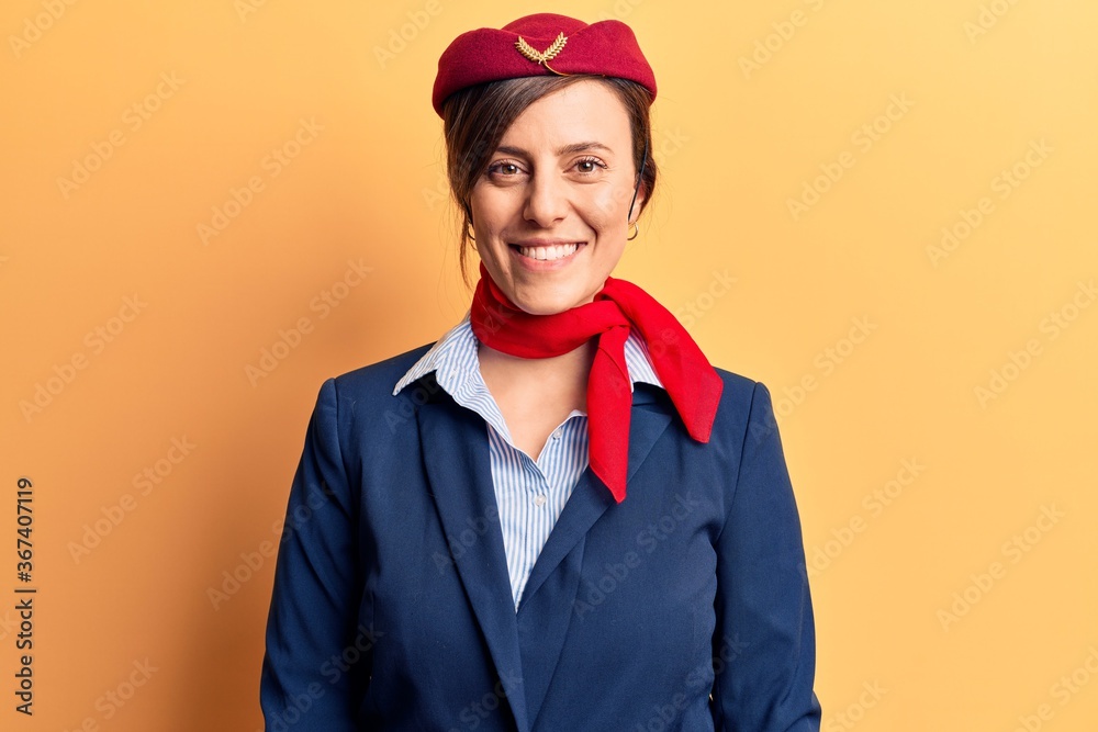 Young beautiful woman wearing stewardess uniform with a happy and cool smile on face. lucky person. Young beautiful woman wearing stewardess uniform with a happy and cool smile on face. lucky person.