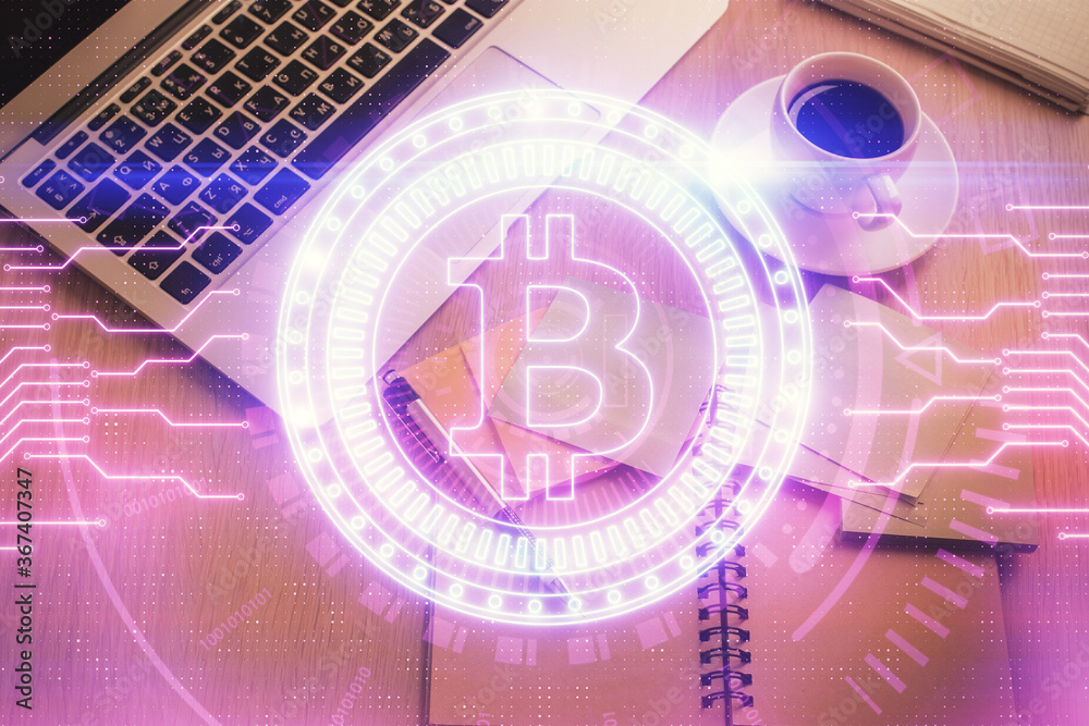 Blockchain theme hologram drawings over computer on the desktop background. Top view. Double exposure. Blockchain theme hologram drawings over computer on the desktop background. Top view. Double exposure.