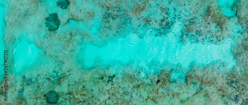 An aerial view of the beautiful Mediterranean sea, where you can se the rocky textured underwater corals and the clean turquoise water of Cyprus, Horizontal Shot for banner or backround