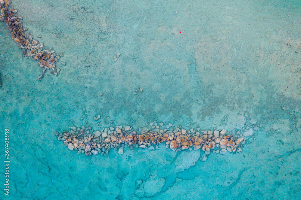 An aerial view of the beautiful Mediterranean sea, where you can se the rocky textured underwater corals and the clean turquoise water of Cyprus An aerial view of the beautiful Mediterranean sea, where you can se the rocky textured underwater corals and the clean turquoise water of Cyprus