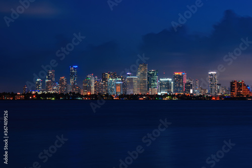 Skyline city miami lighting lights sea ocean sunset night cityscape buildings downtown, architecture skyscraper dusk panorama. Miami.