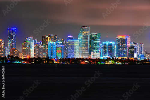 Skyline city miami lighting lights sea ocean sunset night cityscape buildings downtown, architecture skyscraper dusk panorama. Miami night downtown. © Volodymyr