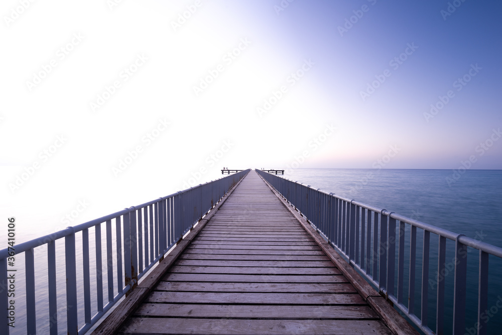 wooden bridge, pier leading to the sea, with copy space above
