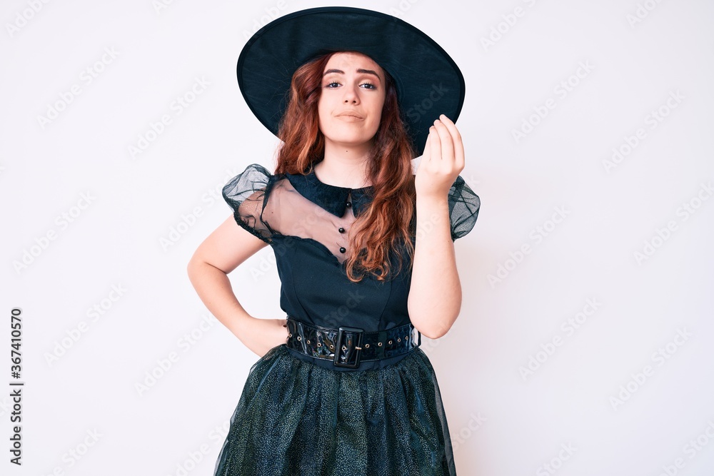 Young beautiful woman wearing witch halloween costume doing italian gesture with hand and fingers confident expression Young beautiful woman wearing witch halloween costume doing italian gesture with hand and fingers confident expression