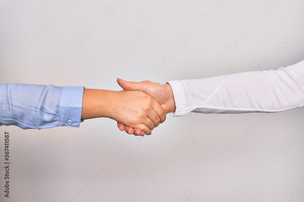 Handshake of two hands of young caucasian businesswomen for agreement over isolated white background