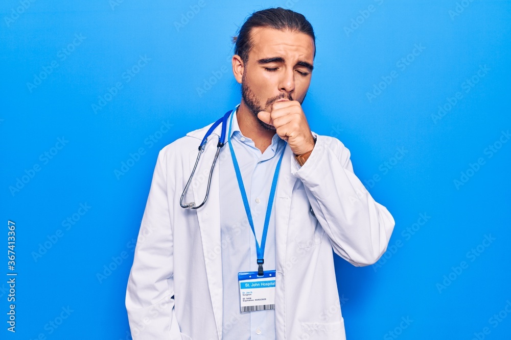 Young handsome man wearing doctor coat and stethoscope feeling unwell and coughing as symptom for cold or bronchitis. health care concept. Young handsome man wearing doctor coat and stethoscope feeling unwell and coughing as symptom for cold or bronchitis. health care concept.