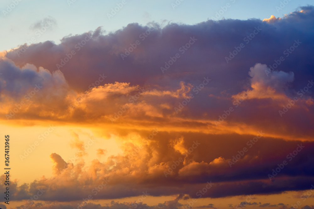Spectacular tropical clouds. Nature background. Blue yellow colors.
