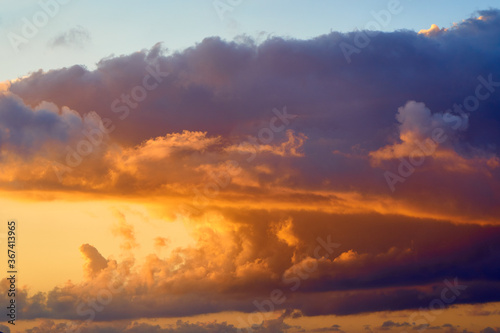 Spectacular tropical clouds. Nature background. Blue yellow colors.